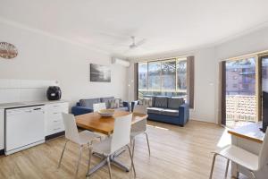 a kitchen and living room with a table and chairs at Martys Little Beach No 14 in Nelson Bay