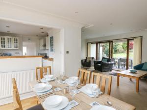 a dining room and living room with a table and chairs at Polkerris View in St Austell