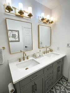 a bathroom with a sink and a mirror at Modern and Spacious Home near downtown and UNL in Lincoln