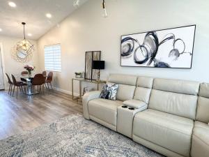 a living room with a white couch and a table at Modern and Spacious Home near downtown and UNL in Lincoln