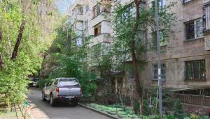 a car parked on a street next to a building at 435 Апартаменты в центре для командированных и туристов in Almaty