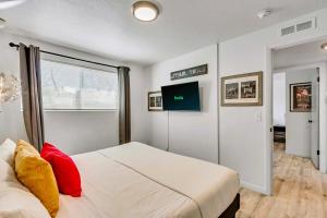 a bedroom with a large white bed with red pillows at Near City Center - Full Kitchen - Fast Wi-Fi in Salt Lake City