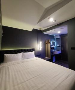 a bedroom with a large white bed in a room at HOTEL JJH - newly opened near BUGIS in Singapore
