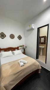 a bedroom with a bed with a mirror and a sink at HOSTEL M&H in Cartagena de Indias +47 photos