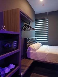 a bedroom with a bed and a tv in it at HOTEL JJH - newly opened near BUGIS in Singapore