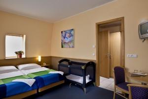 Postel nebo postele na pokoji v ubytování Jagelló Business Hotel