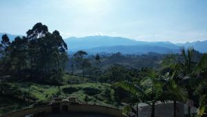 - une vue sur une vallée avec des montagnes en arrière-plan dans l'établissement Aguas Claras Luxury Hospedaje, à Filandia