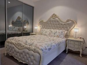 a bedroom with a large white bed and a mirror at Sapphire Royale Suite in Macquarie Park in Sydney