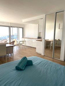a bedroom with a bed and a kitchen and a dining room at Studio vue mer exceptionnelle proche métro et bus in Marseille