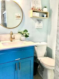a bathroom with a blue vanity and a toilet at Garden Clara in Yuba City
