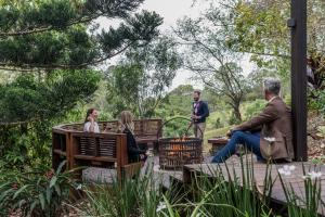a group of people sitting on benches in a garden at Spicers Clovelly Estate in Montville
