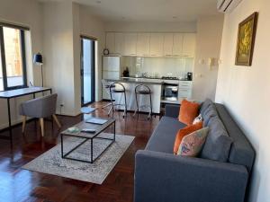 a living room with a couch and a table at Superb City Views - Apartment, work or just relax! in Melbourne