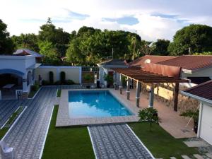 a swimming pool in the backyard of a house at La Romana Countryside Haven in Anao