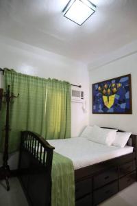 a bedroom with a bed with a green curtain at La Romana Countryside Haven in Anao