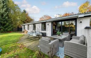 a patio with wicker chairs and a table at Lovely Home In Frvang With Wifi in Fårvang