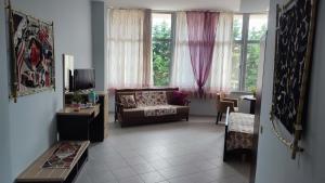 a living room with a couch and a window at 10 apartmants Olimpia MIR in Durrës