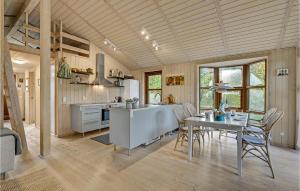 a kitchen and dining room with a table and chairs at Stunning Home In Fårvang With Wifi in Fårvang