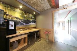 a bathroom with a sink and a large painting on the wall at Subiztel in Pohang