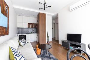 TV a/nebo společenská místnost v ubytování Cosy Home Paupys