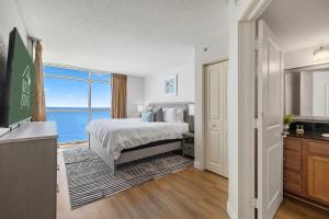 a bedroom with a bed and a view of the ocean at The Grand Myrtle BAY VIEW 1503 Full New Remodel in Myrtle Beach