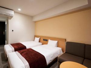 Postel nebo postele na pokoji v ubytování Daiwa Roynet Hotel Nagoya Shinkansenguchi