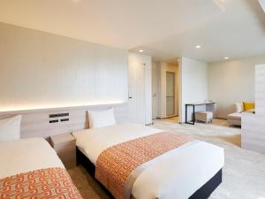 Postel nebo postele na pokoji v ubytování Daiwa Roynet Hotel Nagoya Shinkansenguchi