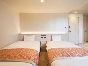 Postel nebo postele na pokoji v ubytování Daiwa Roynet Hotel Nagoya Shinkansenguchi