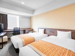 Postel nebo postele na pokoji v ubytování Daiwa Roynet Hotel Nagoya Shinkansenguchi