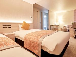 Postel nebo postele na pokoji v ubytování Daiwa Roynet Hotel Nagoya Shinkansenguchi