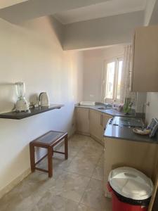 a kitchen with a sink and a stool in it at View Villa Apartments Hurghada in Hurghada