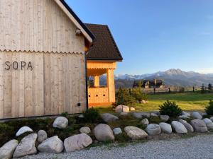 a group of rocks in front of a building at SOPA Zakopane in Zakopane