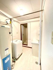 a room with a bathroom with a sink and a refrigerator at Avidasion - Vacation STAY 13342 in Biei