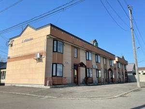 a brown building on the corner of a street at Avidasion - Vacation STAY 13342 in Biei