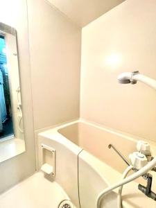 a bathroom with a bath tub and a sink at Avidasion - Vacation STAY 13343 in Biei