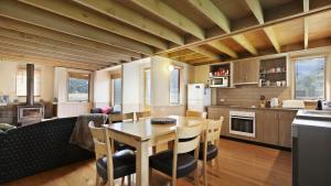 a kitchen and dining room with a table and chairs at Breck in Dinner Plain