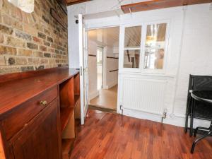 a kitchen with a brick wall and a door at The Fox and Punchbowl in Windsor