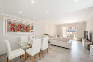 a living room with a table and chairs and a couch at Villa Alma Azul in Llucmajor