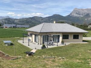 a small house with a view of a mountain at Magnifique Villa Sabot de Venus in Le Lautaret