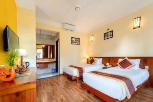 Postel nebo postele na pokoji v ubytování Hoi An Green Riverside Oasis Villa