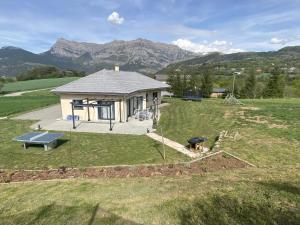 an aerial view of a house in a field at Magnifique Villa Sabot de Venus in Le Lautaret +12 photos