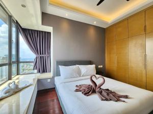 a bedroom with two swans on a bed at R&F Princess Cove CIQ Premium Sea View Suites by NEO in Johor Bahru