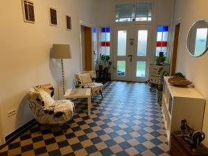 a living room with two chairs and a table at Pension Grunwald in Sehnde