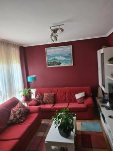 a red living room with a red couch at URIFER in Cóbreces