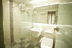 a bathroom with a sink and a toilet and a mirror at Ariana Hotel in Daegu +31 photos