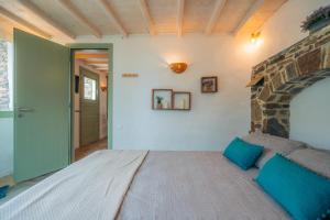 a bedroom with a large bed in a room at Houses at Chrisopigi Sifnos in Chrisopigi