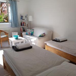 a living room with two beds and a couch at Strand & Garten in Surendorf