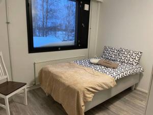 a small bedroom with a bed with a window at 2BR with sauna in Tornio city in Tornio