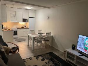 a living room with a table and chairs and a kitchen at 2BR with sauna in Tornio city in Tornio