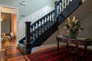 a living room with a staircase and a table at Casa da Marechal - Boutique Hotel by Oporto Collection - Adults Only in Porto