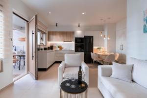 a living room with a white couch and a table at Mariann Premium Suites in Lartos